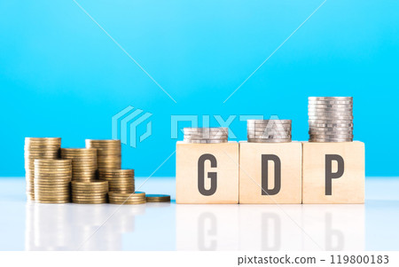Wooden block labeled 'GDP' alongside a stack of coins. Symbolizes economic growth, emphasizing the significance of Gross Domestic Product in assessing financial progress and national prosperity 119800183