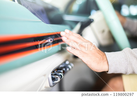 Car owner checks the air conditioning system by feeling the cool air from the vent after the vehicle has been flooded. Concept of vehicle maintenance, focusing on post-flood cooling system inspections Car owner checks the air conditioning system by feeling the cool air from the vent after the vehicle has been flooded. Concept of vehicle maintenance, focusing on post-flood cooling system inspections 119800297