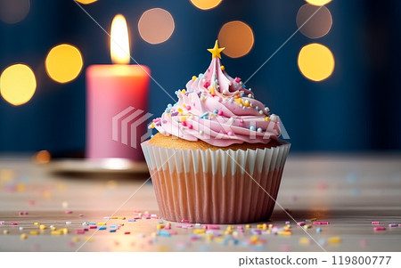 a birthday cake or muffin adorned with lights against a vibrant pink background. 119800777