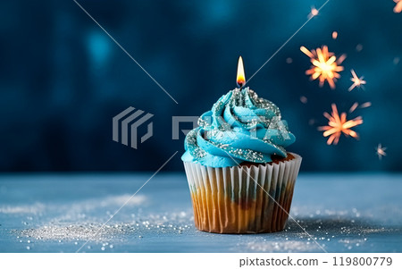 a birthday cake or muffin adorned with lights against a vibrant blue background. 119800779
