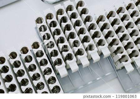 Close-up image of laboratory equipment arranged neatly for sample handling purposes. Image showcases clean and organized environment essential for scientific research 119801063