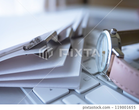 Documents, keyboard, and watch on the table Documents, keyboard, and watch on the table 119801655