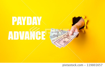 A hand holding a stack of money with the words Payday Advance written below A hand holding a stack of money with the words Payday Advance written below 119801657