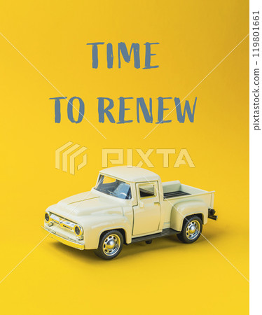 A toy truck is on a yellow background with the words Time to Renew A toy truck is on a yellow background with the words Time to Renew 119801661