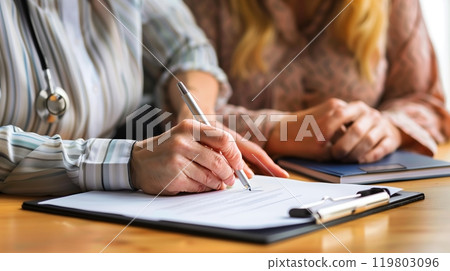 A person with a hearing impairment signs a contract, aided by a sign language interpreter and a lawyer. A person with a hearing impairment signs a contract, aided by a sign language interpreter and a lawyer. 119803096