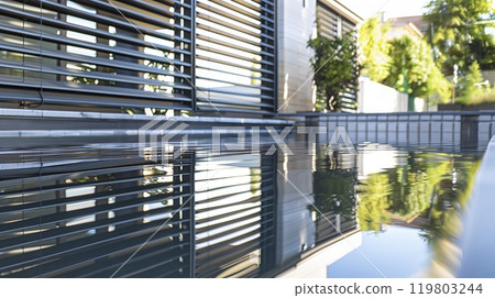 A serene twilight beach shows a sea turtles silhouette, slowly making its way to the water - peaceful beauty. 119803244