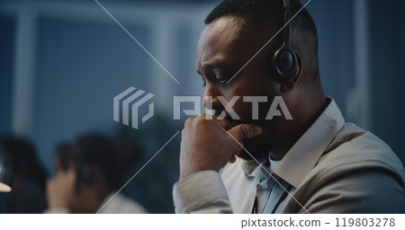 African American hotline specialist in headset providing online psychological assistance 119803278