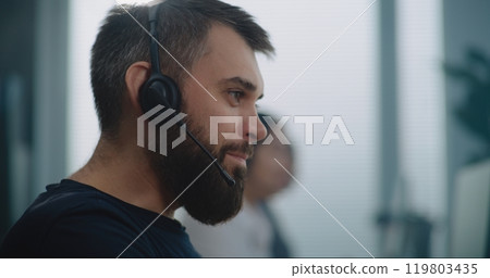 Close up portrait of Caucasian technical support specialist in headset communicating Close up portrait of Caucasian technical support specialist in headset communicating 119803435