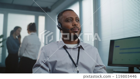 African American technical customer support specialist in headset looking at camera 119803446