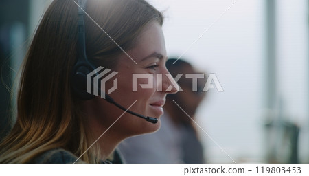 Close up of young technical customer support specialist in headset providing online help 119803453