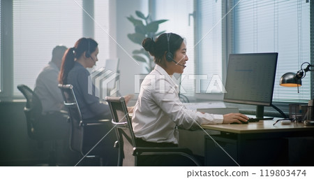 Diverse team of technical support operators in modern call center office Diverse team of technical support operators in modern call center office 119803474