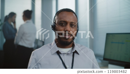 African American technical customer support specialist in headset looking at camera 119803482