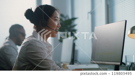 Call center office: Portrait of Asian hotline operator talking on headset 119803495