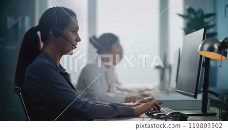 Portrait of Caucasian hotline operator talking on headset, providing online assistance for client Portrait of Caucasian hotline operator talking on headset, providing online assistance for client 119803502