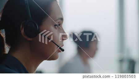Close up of Caucasian female hotline operator in headset having conversation on call 119803503