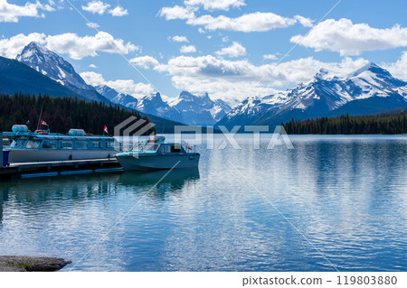 Maligne Lake Cruise boat pier. Maligne Lake summer scenery reflected on the water. Jasper National Park, Alberta, Canada. Canadian Rockies. Maligne Lake Cruise boat pier. Maligne Lake summer scenery reflected on the water. Jasper National Park, Alberta, Canada. Canadian Rockies. 119803880
