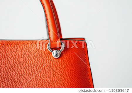 close-up of a stylish orange women's handbag on a white background close-up of a stylish orange women's handbag on a white background 119805647