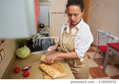 Woman preparing bread in a modern kitchen setting 119806058