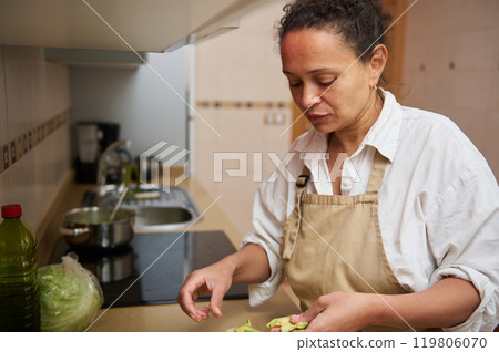 Woman preparing vegetables in a home kitchen 119806070