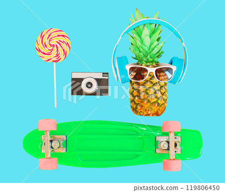 Pineapple with headphones sunglasses lollipop, vintage camera skateboard on colorful blue background Pineapple with headphones sunglasses lollipop, vintage camera skateboard on colorful blue background 119806450
