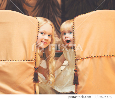 Christmas children little girls sit at the table at home 119806580
