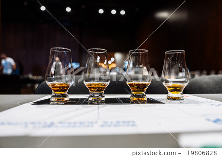 Exploring diverse flavors at an alcohol tasting event in a stylish venue 119806828