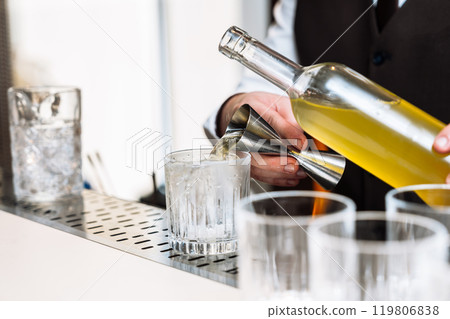 Cocktail preparation at a stylish bar during an evening tasting event 119806838