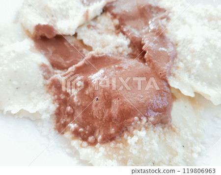 Italian pasta dish called tortelli or casoncelli with wine sauce and grated cheese Italian pasta dish called tortelli or casoncelli with wine sauce and grated cheese 119806963