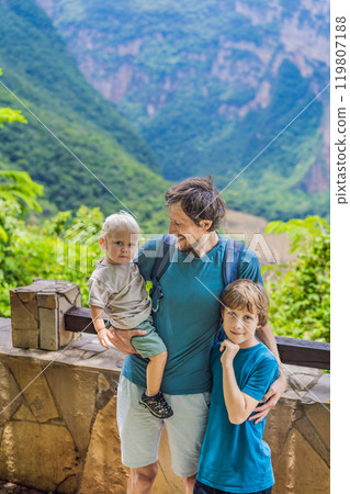 Dad and his two sons baby and teenager travelers exploring Sumidero Canyon National Park, Mexico. Adventure, natural exploration, and travel experience concept Dad and his two sons baby and teenager travelers exploring Sumidero Canyon National Park, Mexico. Adventure, natural exploration, and travel experience concept 119807188
