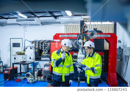 Technician engineer using remote control automation robotics at industrial modern lab factory. Team technological researching and developing working at factory innovation automation robot. 119807243