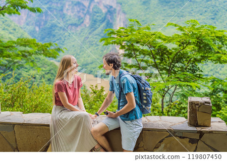 Man and woman embracing and admiring the view of Sumidero Canyon National Park, Mexico. Love, honeymoon, nature, and travel experience concept Man and woman embracing and admiring the view of Sumidero Canyon National Park, Mexico. Love, honeymoon, nature, and travel experience concept 119807450