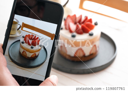 Photographing strawberry cake with a smartphone 119807761