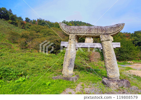 Stone torii gate standing on a slope Stone torii gate standing on a slope 119808579