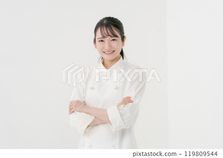 Portrait of a female chef with her arms crossed Portrait of a female chef with her arms crossed 119809544