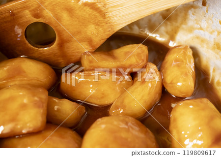 Tarte Tatin apples cooked in butter and sugar 119809617