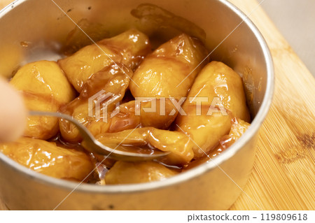 Tarte Tatin apples cooked in butter and sugar 119809618