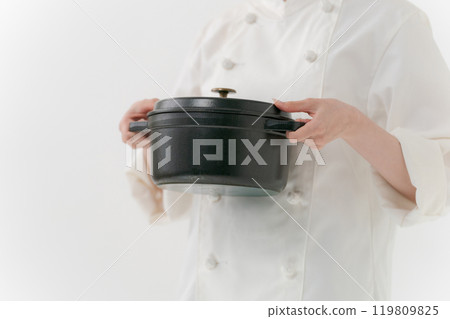 The hands of a female chef holding a pot The hands of a female chef holding a pot 119809825