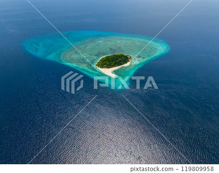 Mantigue Island surrounded by deep blue sea with sunlight reflection. Camiguin, Philippines. Mantigue Island surrounded by deep blue sea with sunlight reflection. Camiguin, Philippines. 119809958