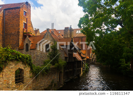 Stone buildings along canal in Bruges, Belgium 119811347