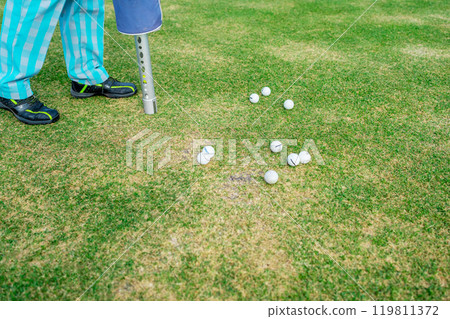 Engaging in a Golf Practice Session with Multiple Balls on the Picturesque Green Area Engaging in a Golf Practice Session with Multiple Balls on the Picturesque Green Area 119811372