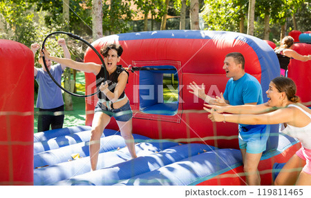 Emotional woman competing to collect hoops on inflatable playground 119811465