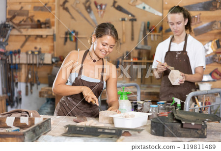 Guy is busy in carpentry workshop with female entrepreneur Guy is busy in carpentry workshop with female entrepreneur 119811489