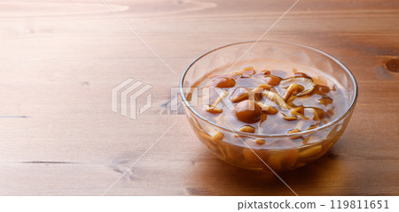 Domestic nameko mushrooms in a transparent container with a unique slimy texture and flavor 119811651