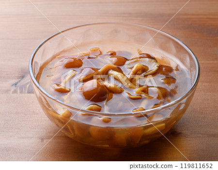 Domestic nameko mushrooms in a transparent container with a unique slimy texture and flavor 119811652