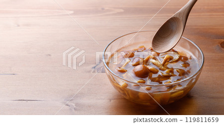 Domestic nameko mushrooms in a transparent container with a unique slimy texture and flavor 119811659
