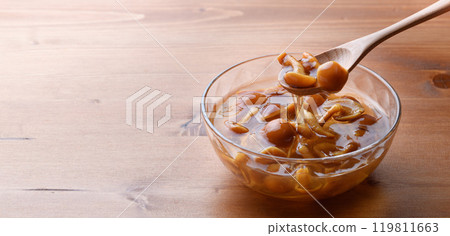 Domestic nameko mushrooms in a transparent container with a unique slimy texture and flavor 119811663