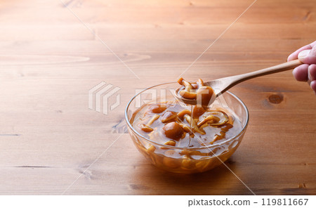 Domestic nameko mushrooms in a transparent container with a unique slimy texture and flavor 119811667