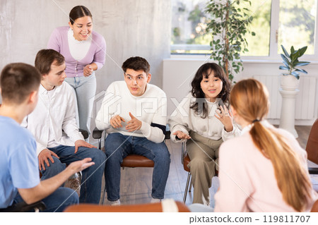 Interested young student taking part in group discussion 119811707