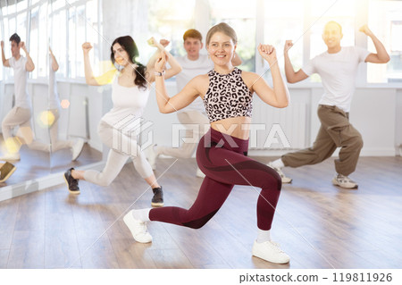 Team of dancers performing contemporary dance in choreography studio 119811926