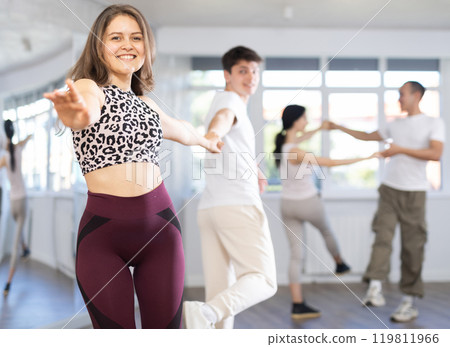 Couples of young men and women dancing twist Couples of young men and women dancing twist 119811966